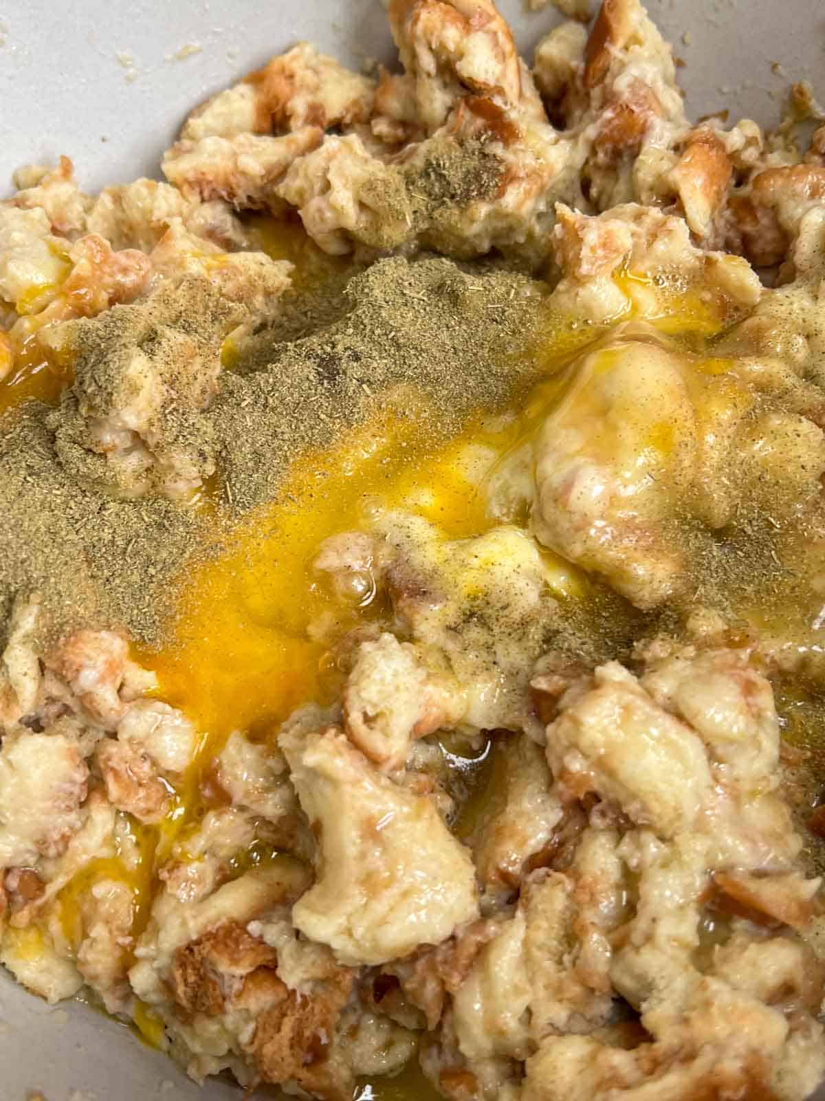 Seasonings and egg added to the top of stuffing mixture.