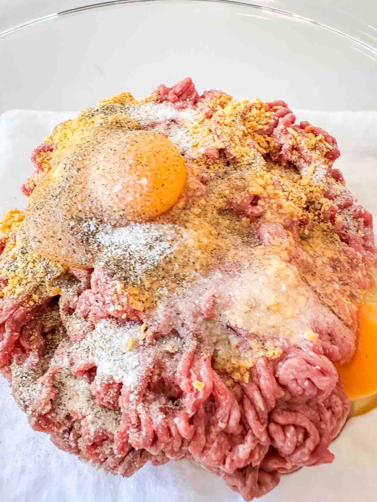 Ingredients for the best meatloaf recipe in a bowl ready to be mixed together.