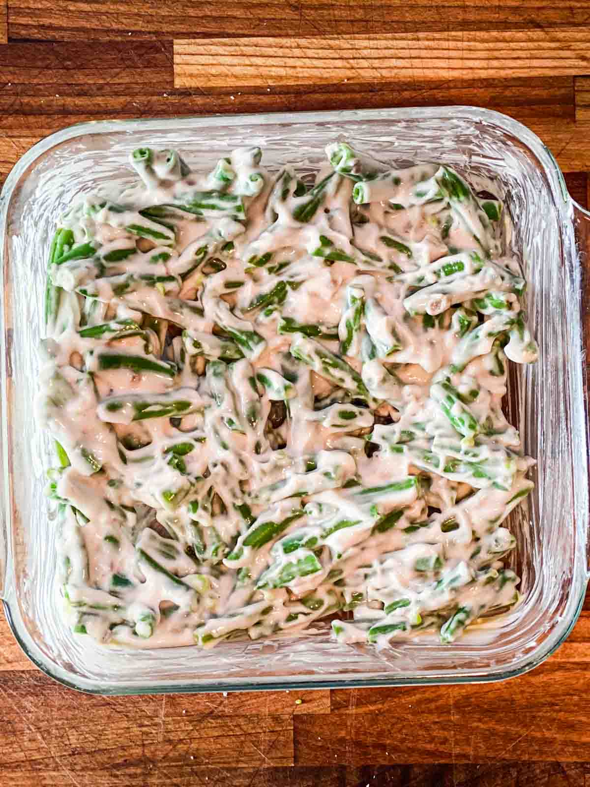 Mixing Campbell's green bean casserole ingredients directly in a casserole dish.