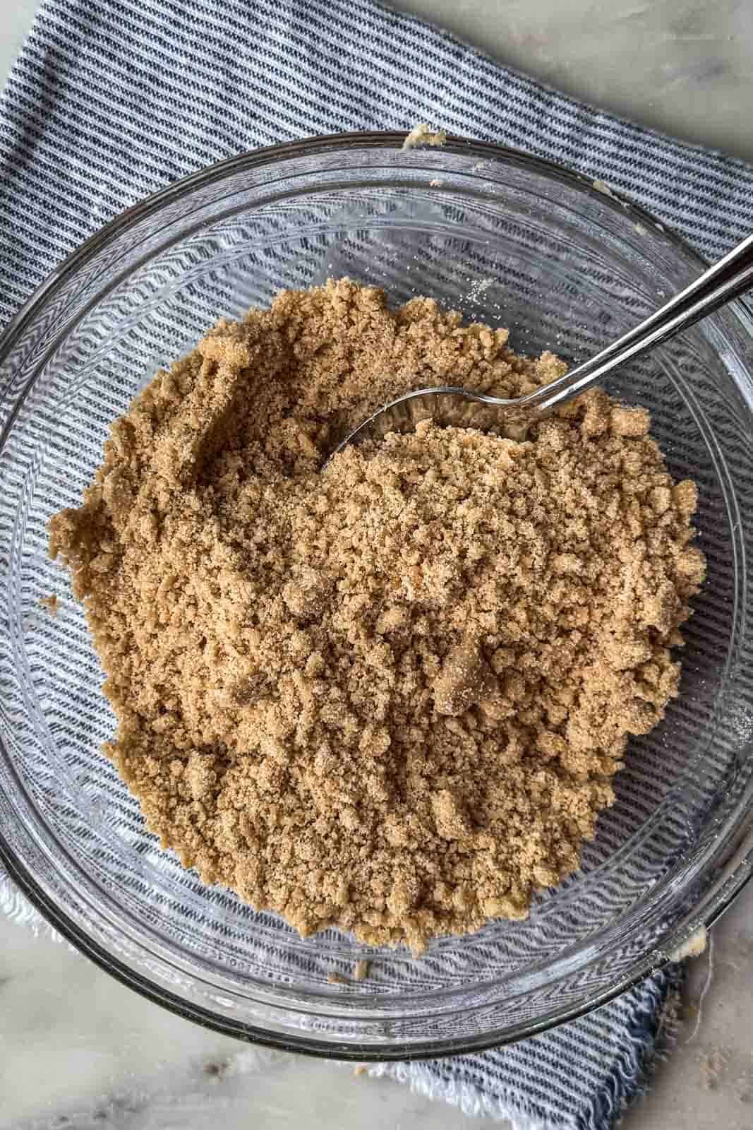 Brown sugar pumpkin spice streusel mixed to a wet sand consistency with small crumbs.
