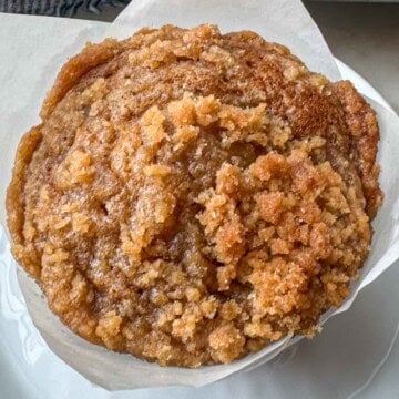Bakery-style pumpkin streusel muffins topped with buttery brown sugar crumb topping.