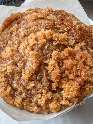 Bakery-style pumpkin streusel muffins topped with buttery brown sugar crumb topping.