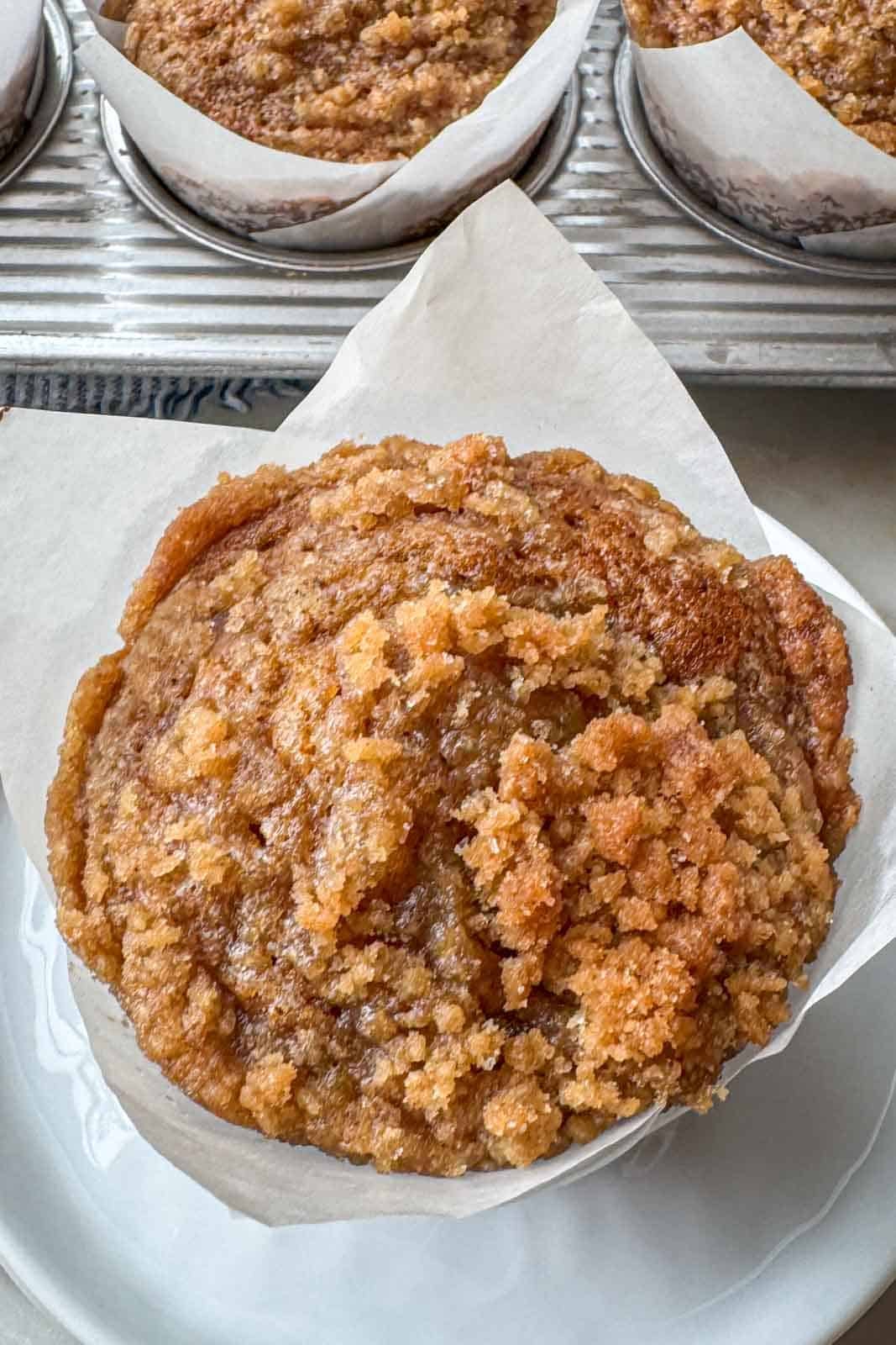 Bakery-style pumpkin streusel muffins topped with buttery brown sugar crumb topping.