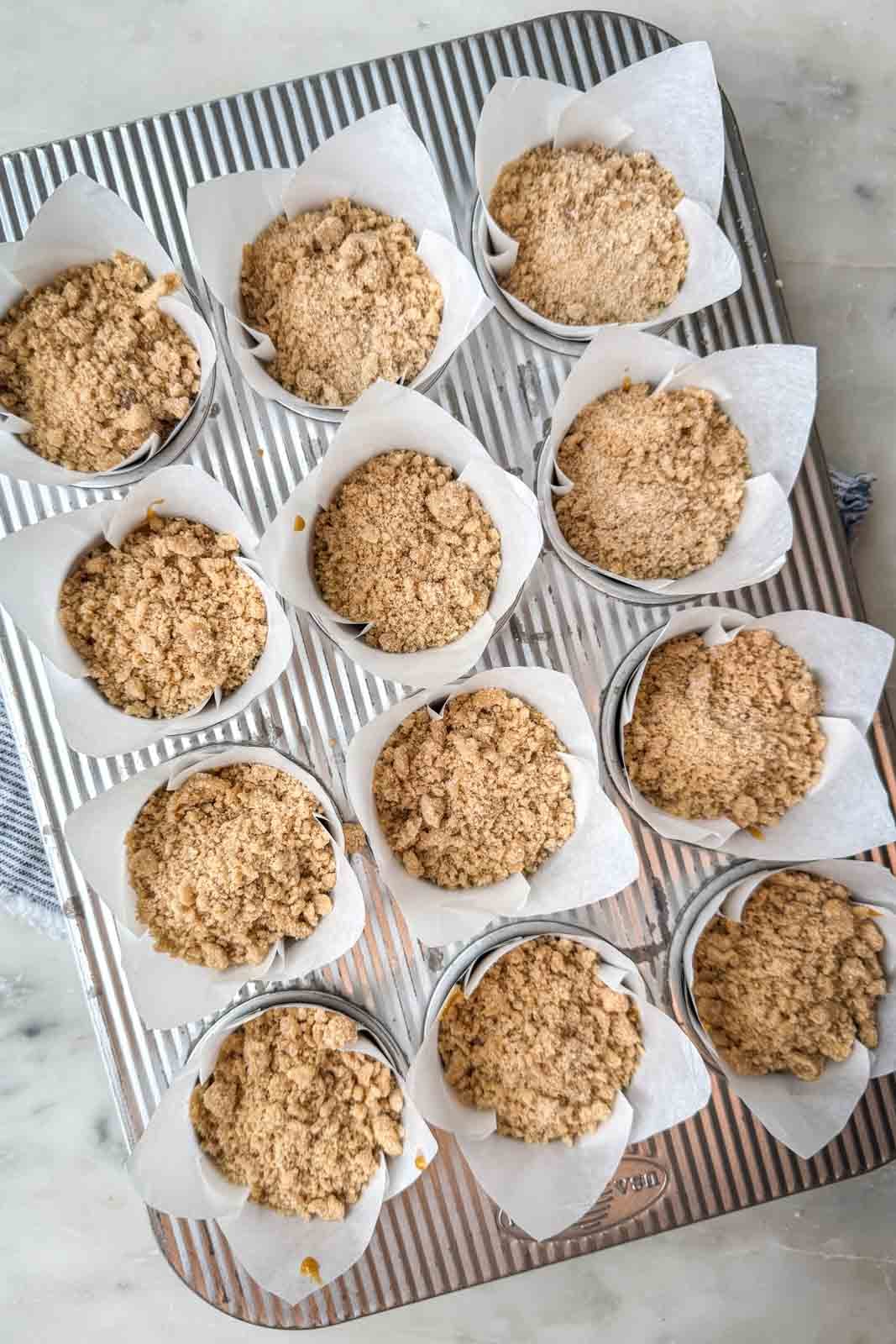 Pumpkin muffins topped with brown sugar pumpkin spice streusel before baking.