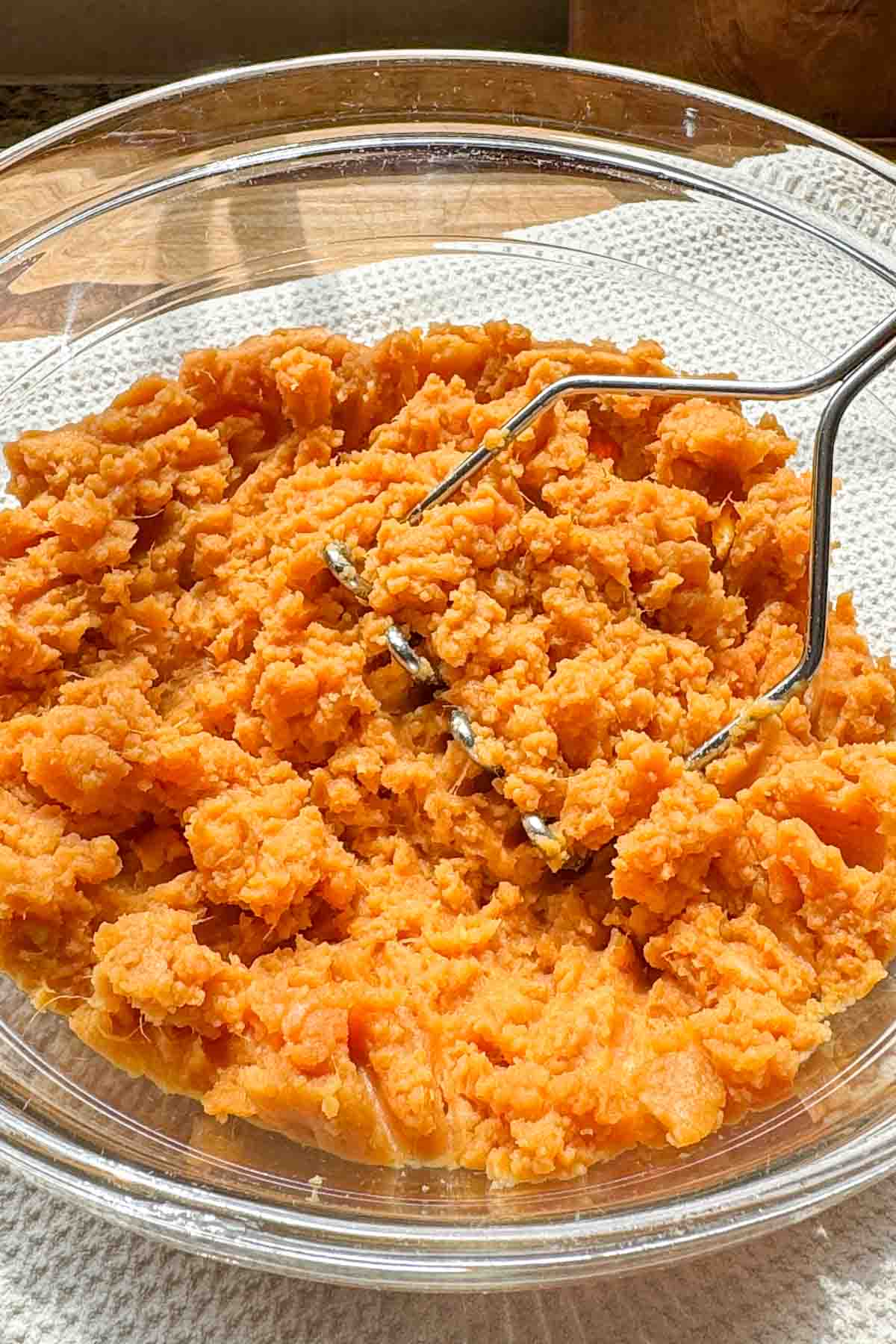 Canned sweet potatoes mashed with a potato masher until mostly smooth.