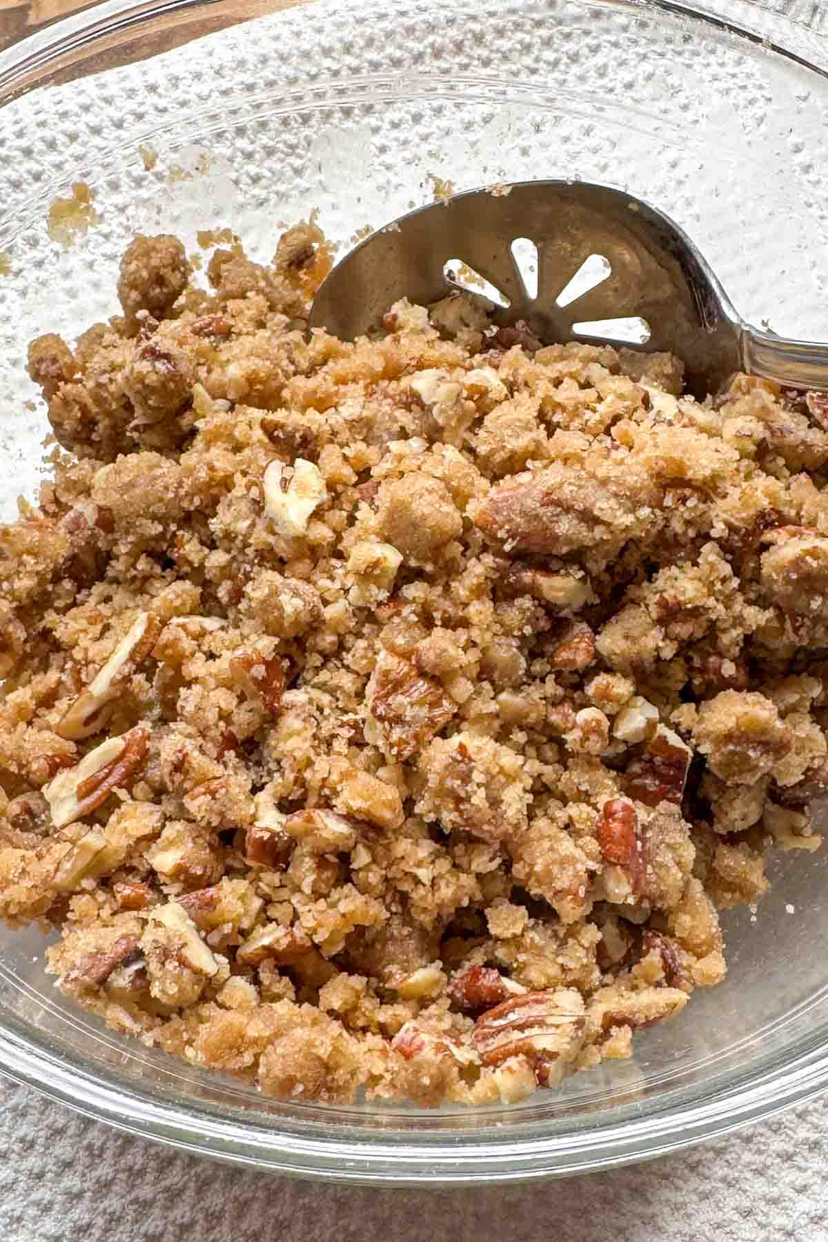 Brown sugar pecan topping mixed to a crumbly wet-sand texture.