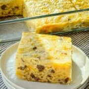 Sausage hash brown breakfast casserole with a generous slice plated.