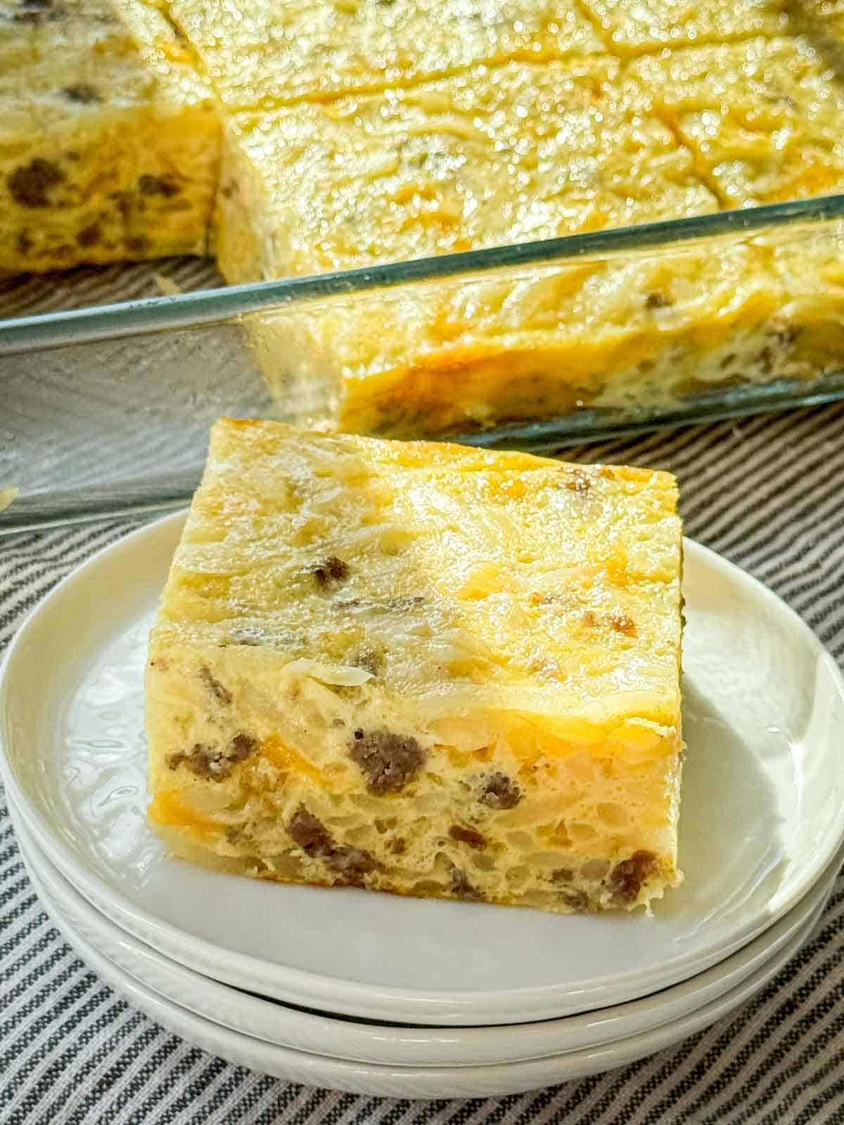 Sausage hash brown breakfast casserole with a generous slice plated.